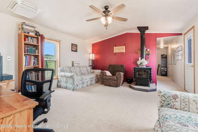 400 Behrman St, Craig, CO 81625 - carpeted living room with a wood stove, ceiling fan, vaulted ceiling, and ornamental molding