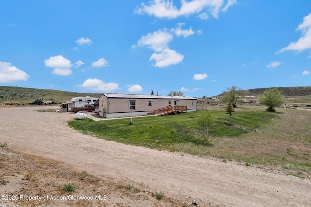 400 Behrman St, Craig, CO 81625 - rear view of house featuring a yard, a view of rural / pastoral area, and driveway