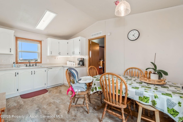 400 Behrman St, Craig, CO 81625 - kitchen featuring white dishwasher, a sink, lofted ceiling, light countertops, and white cabinets