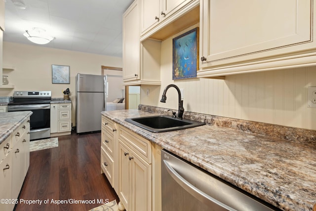 1026 Palmer Ave, Glenwood Springs, CO 81601 - kitchen featuring appliances with stainless steel finishes, dark wood-style floors, and light stone counters