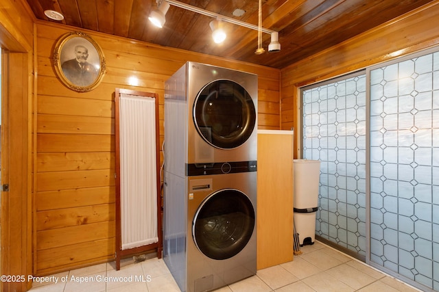 1026 Palmer Ave, Glenwood Springs, CO 81601 - washroom with stacked washer / dryer, wood ceiling, wooden walls, and light tile patterned floors
