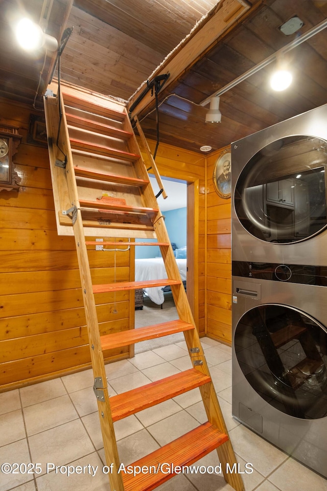 1026 Palmer Ave, Glenwood Springs, CO 81601 - laundry room featuring stacked washer / dryer, wooden walls, tile patterned floors, and wooden ceiling
