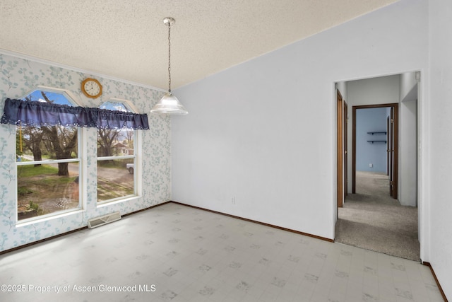unfurnished dining area with a textured ceiling, tile patterned floors, baseboards, wallpapered walls, and visible vents