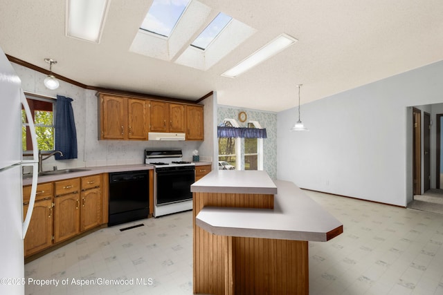 kitchen with a sink, light countertops, light floors, under cabinet range hood, and white appliances