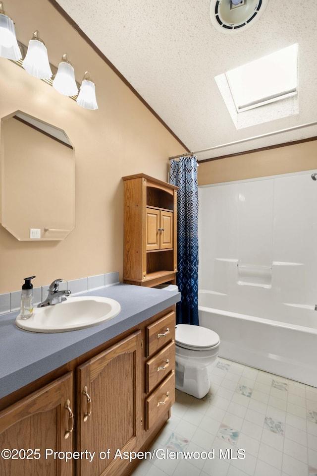 full bath with vanity, crown molding, toilet, shower / bathtub combination with curtain, and vaulted ceiling with skylight