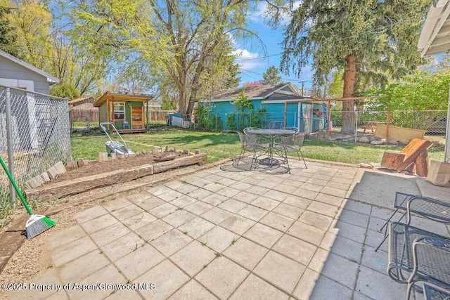 view of patio with a storage shed, an outdoor structure, and outdoor dining space