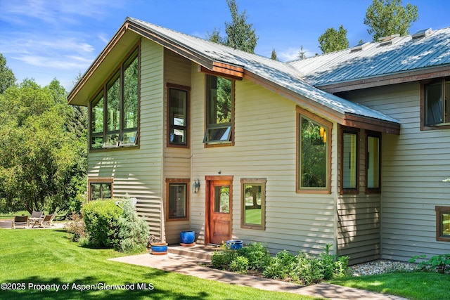 2755 Lower River Rd, Snowmass, CO 81654 - view of front of home with a front lawn and a metal roof
