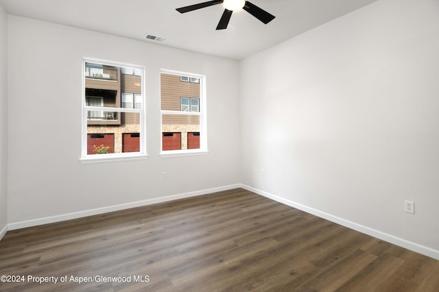 empty room featuring ceiling fan and dark hardwood / wood-style flooring