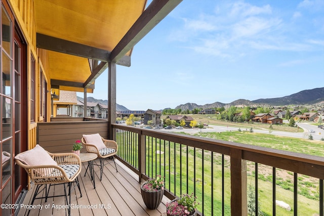 balcony featuring a residential view and a mountain view