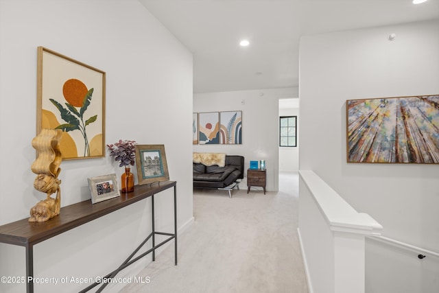 hallway featuring carpet floors, recessed lighting, an upstairs landing, and baseboards