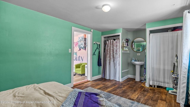 bedroom featuring sink and dark wood-type flooring