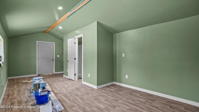 bonus room featuring vaulted ceiling with beams and light hardwood / wood-style floors