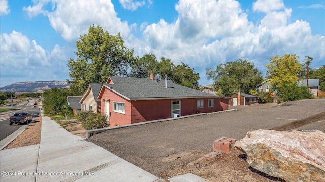 view of property exterior with a mountain view