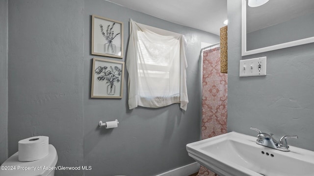 bathroom featuring sink and toilet