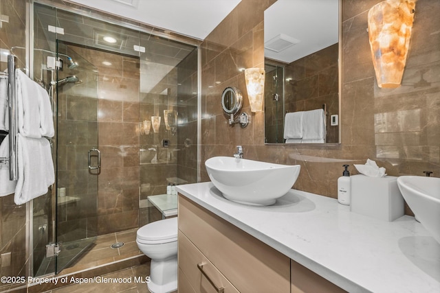 610 S W End St Unit K102, Aspen, CO 81611 - bathroom featuring tile walls, vanity, a shower stall, toilet, and backsplash