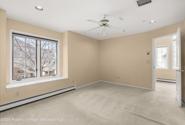 spare room featuring visible vents, recessed lighting, baseboard heating, and light colored carpet