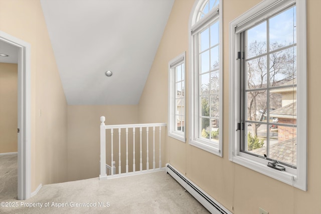 bonus room featuring lofted ceiling, carpet flooring, and a baseboard radiator