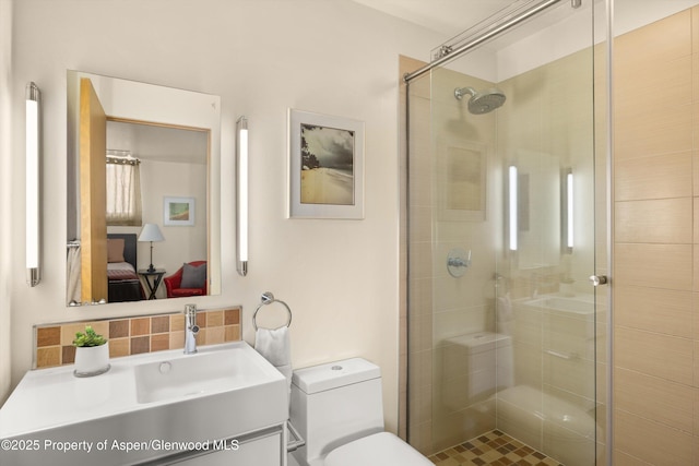 2633 Dolores Way, Carbondale, CO 81623 - ensuite bathroom featuring toilet, tasteful backsplash, a stall shower, vanity, and ensuite bath
