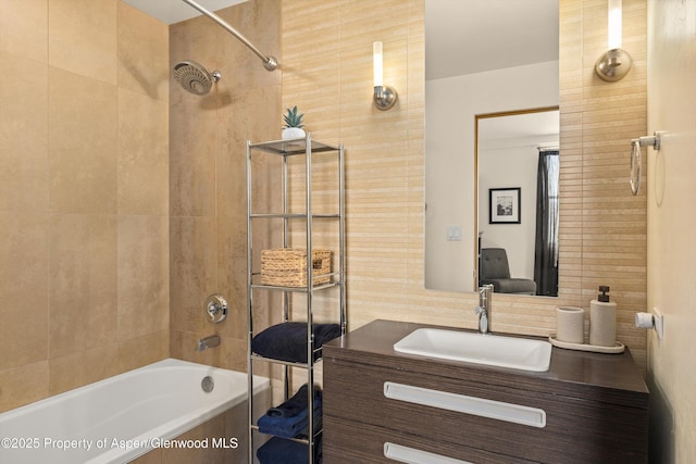 2633 Dolores Way, Carbondale, CO 81623 - bathroom with tile walls, vanity, tiled shower / bath combo, and tasteful backsplash