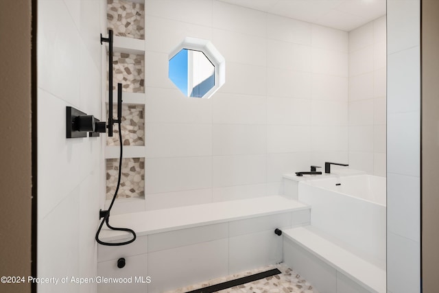 bathroom with tile walls