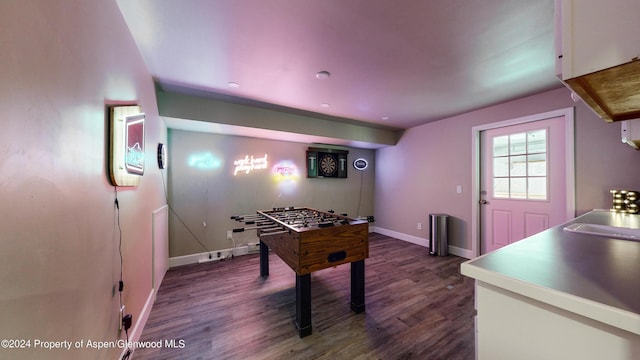 rec room featuring baseboards, dark wood-type flooring, and a sink