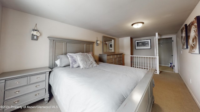 bedroom with light colored carpet and baseboards