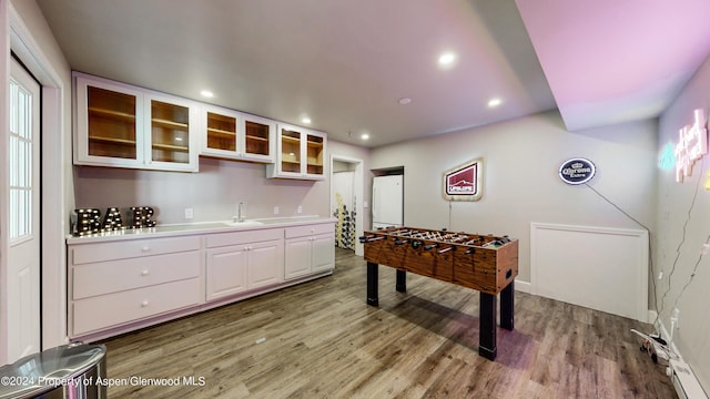 playroom featuring recessed lighting, a sink, and wood finished floors