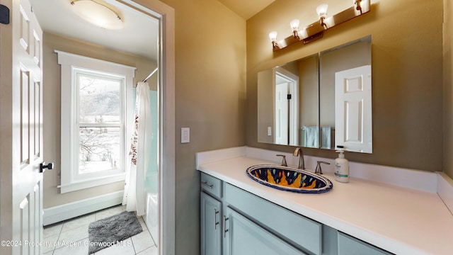 bathroom with tile patterned floors, baseboards, and vanity