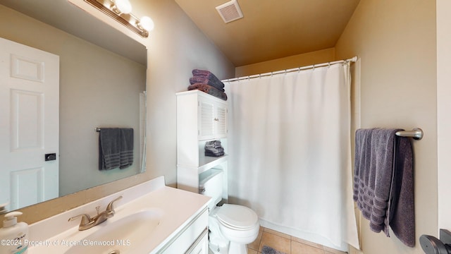 bathroom with curtained shower, visible vents, toilet, vanity, and tile patterned flooring