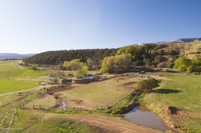 aerial view featuring a rural view and a water and mountain view