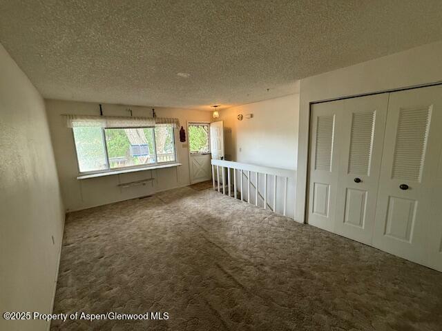 872 Russell St, Craig, CO 81625 - empty room with a textured ceiling and carpet floors