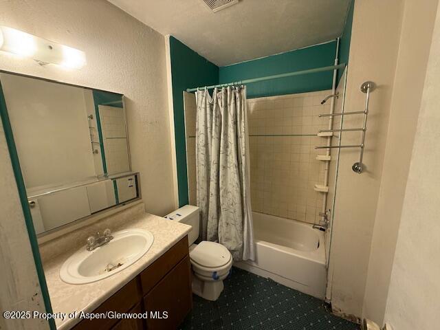 872 Russell St, Craig, CO 81625 - bathroom with vanity, toilet, shower / bathtub combination with curtain, and tile patterned flooring