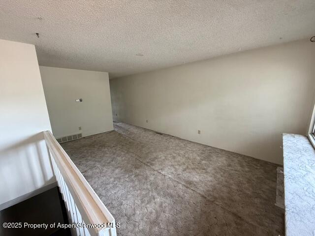872 Russell St, Craig, CO 81625 - empty room featuring carpet flooring and a textured ceiling
