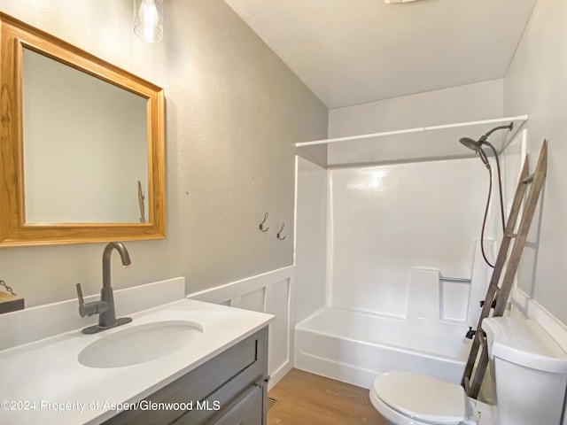 full bathroom with shower / bathing tub combination, hardwood / wood-style floors, vanity, and toilet