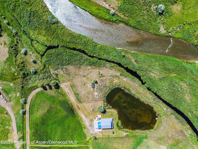 bird's eye view with a water view and a rural view