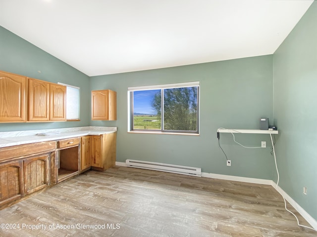 laundry room with light wood-type flooring and baseboard heating