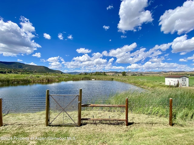 exterior space with a water and mountain view