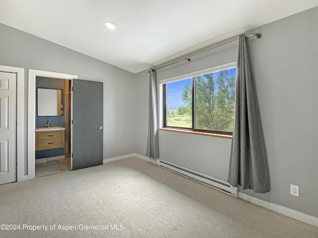 unfurnished bedroom featuring lofted ceiling, ensuite bathroom, sink, carpet flooring, and a baseboard radiator