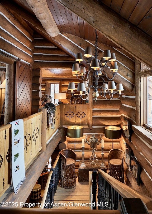 details with a notable chandelier, wooden ceiling, rustic walls, and beamed ceiling