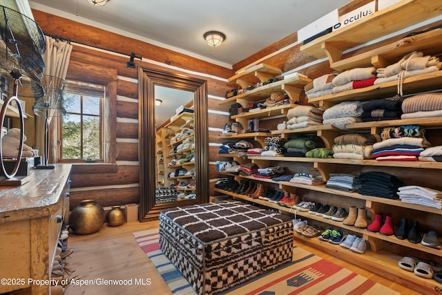 walk in closet with light wood-type flooring