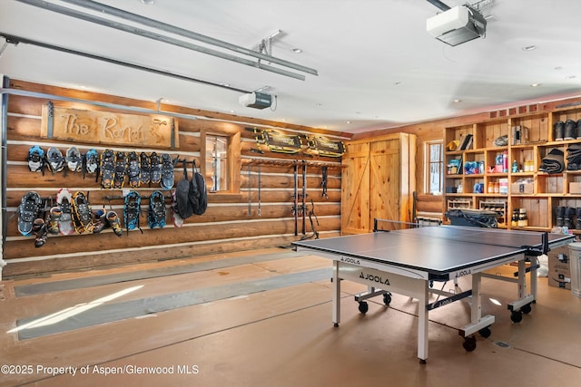 playroom featuring concrete flooring and log walls