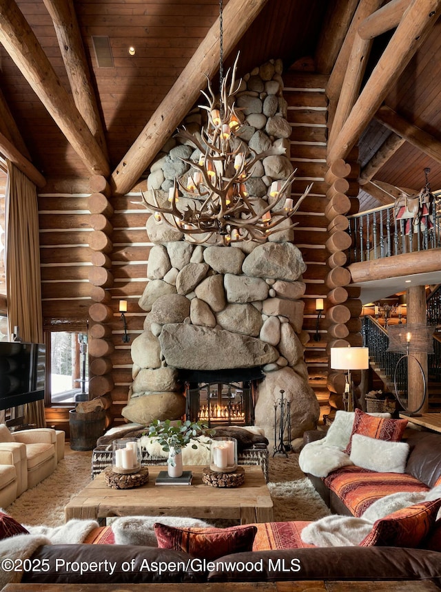 living room featuring wood ceiling, a fireplace, an inviting chandelier, and vaulted ceiling with beams