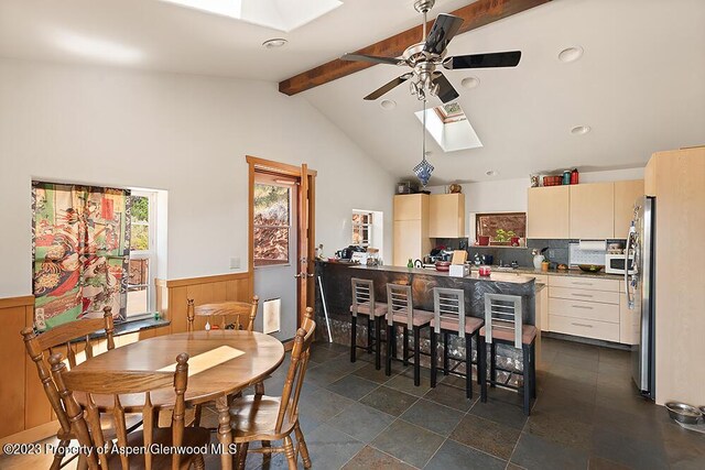 2800 Cedar Dr, Basalt, CO 81621 - dining room featuring a skylight, beamed ceiling, a wainscoted wall, a ceiling fan, and recessed lighting