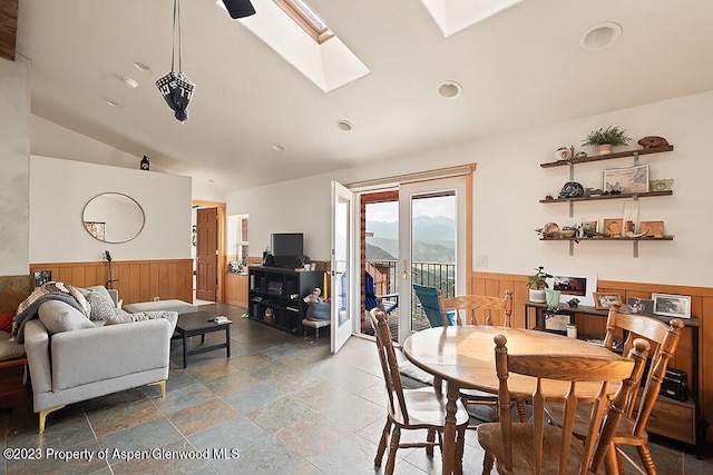 2800 Cedar Dr, Basalt, CO 81621 - dining space featuring a wainscoted wall, lofted ceiling, a skylight, stone tile floors, and recessed lighting