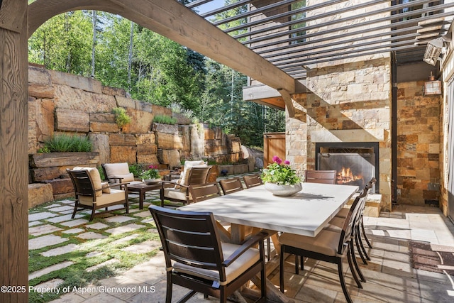 10 Ute Pl, Aspen, CO 81611 - view of patio with an outdoor stone fireplace and outdoor dining area