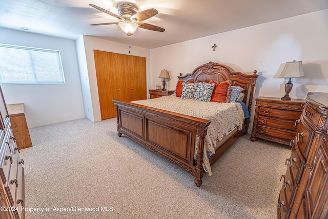 bedroom with light colored carpet, a closet, and ceiling fan
