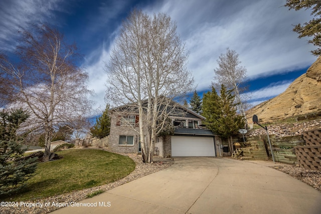 view of front of home with driveway, brick siding, and a garage
