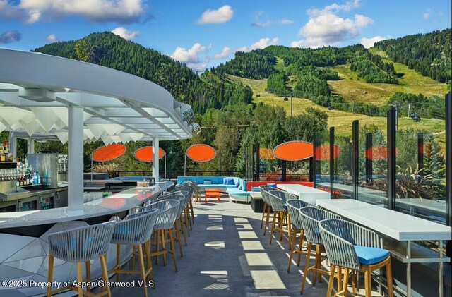 550 S Spring St Unit F8-10, Aspen, CO 81611 - view of patio / terrace featuring a view of trees and a mountain view