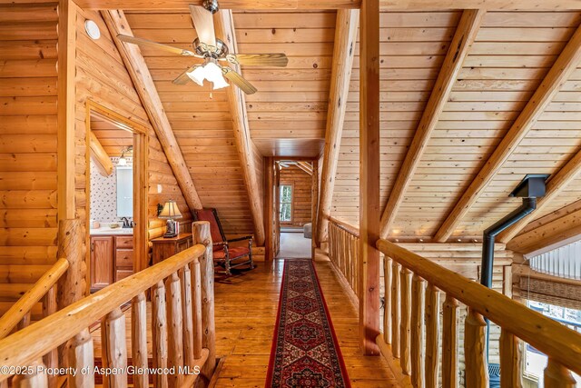 3 Hazel Lake Dr, Cimarron, CO 81220 - hallway with log walls, hardwood / wood-style floors, wood ceiling, healthy amount of natural light, and an upstairs landing