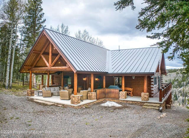 3 Hazel Lake Dr, Cimarron, CO 81220 - view of front of house featuring a standing seam roof, an outdoor living space, log siding, and metal roof